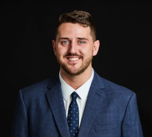 Headshot of Ryan Mansell, Head of Electrical and Electronics, smiling at the camera.